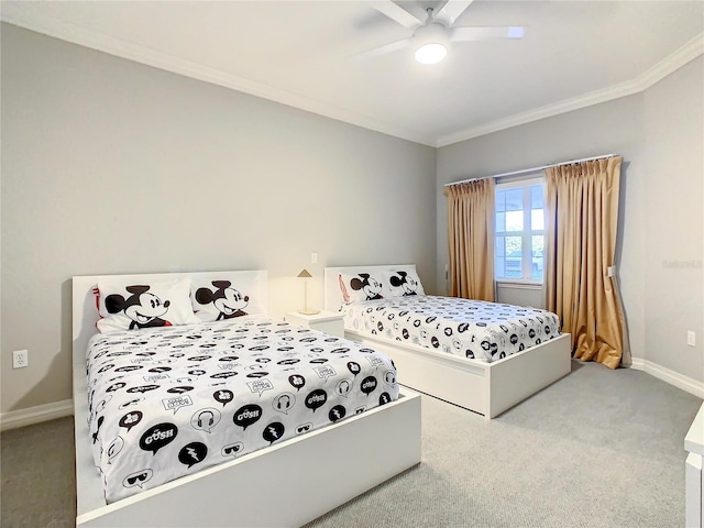 carpeted bedroom featuring a ceiling fan, baseboards, and ornamental molding