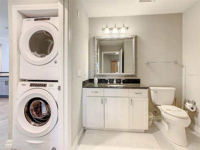 interior space with stacked washer / dryer, light tile patterned floors, and sink