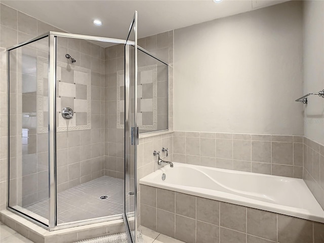 bathroom featuring independent shower and bath and tile patterned flooring