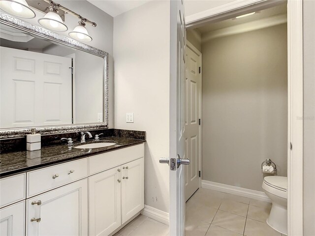 bathroom with tile patterned floors, toilet, and vanity