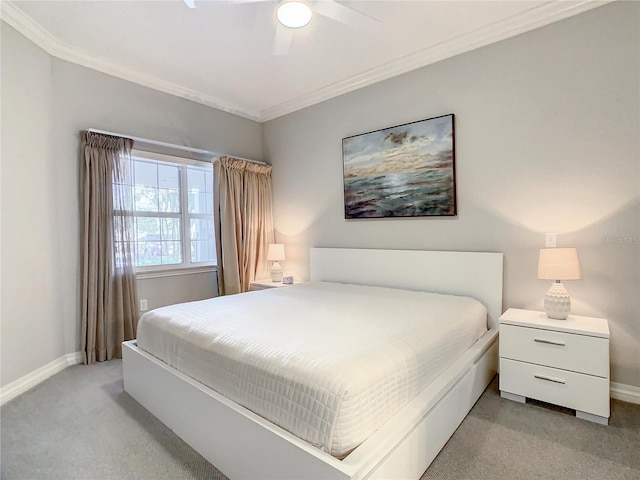 bedroom with crown molding, baseboards, and light carpet