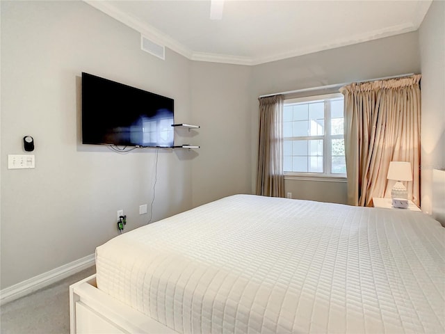 bedroom featuring visible vents, ornamental molding, a ceiling fan, carpet floors, and baseboards