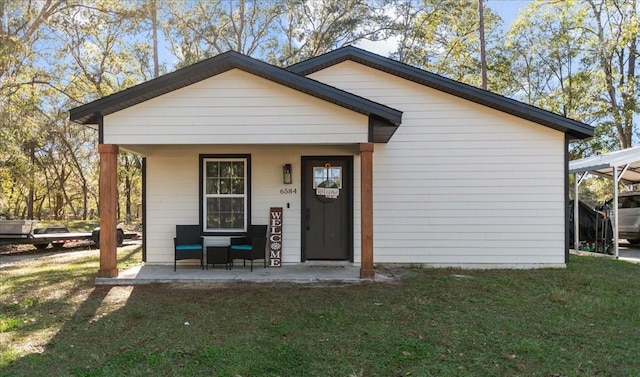 exterior space with covered porch and a front yard