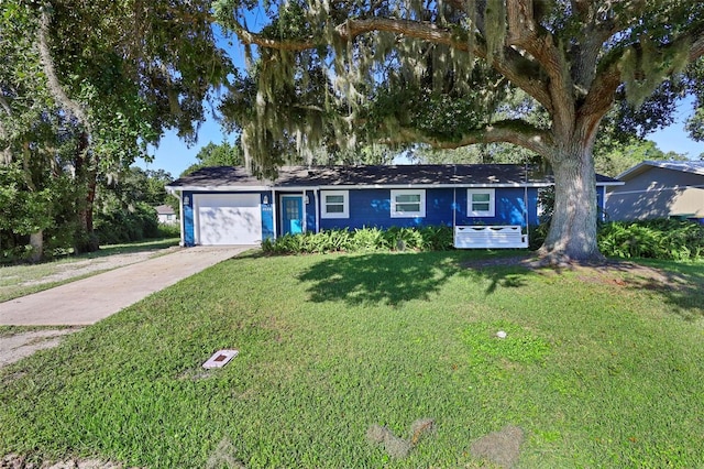 ranch-style house with a garage and a front lawn