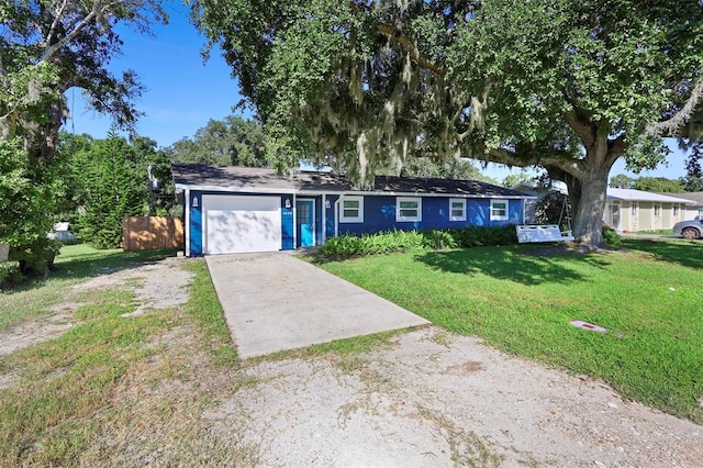 ranch-style house with a garage and a front lawn