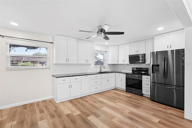 kitchen with a healthy amount of sunlight, light wood-type flooring, sink, and appliances with stainless steel finishes