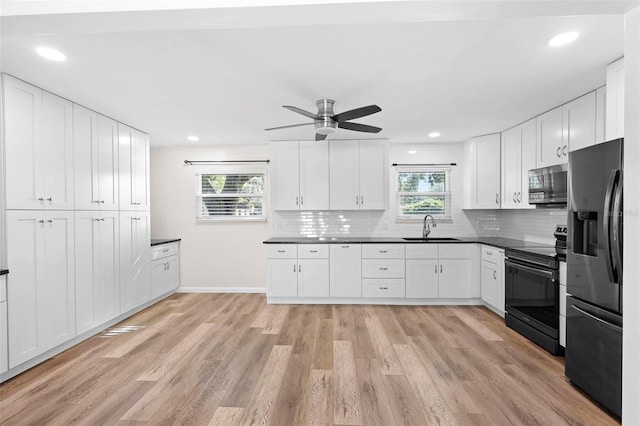 kitchen with black appliances, ceiling fan, light hardwood / wood-style floors, and sink