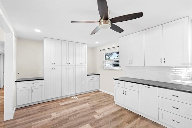 kitchen featuring ceiling fan, light wood-type flooring, white cabinets, and tasteful backsplash