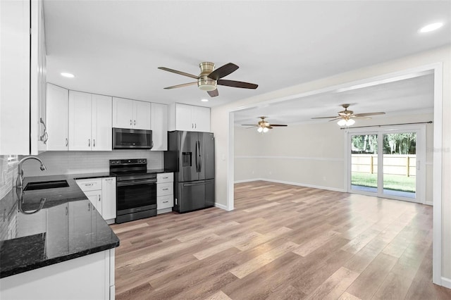 kitchen with light hardwood / wood-style flooring, stainless steel appliances, sink, white cabinetry, and ceiling fan