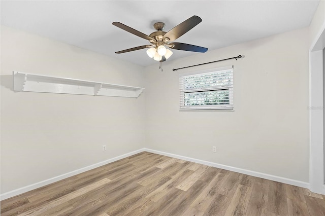 spare room featuring hardwood / wood-style floors and ceiling fan