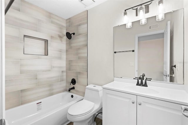 full bathroom with toilet, tiled shower / bath combo, and vanity