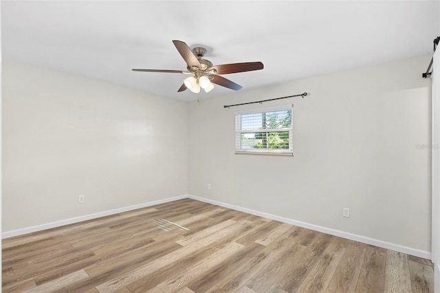 spare room featuring light hardwood / wood-style flooring and ceiling fan