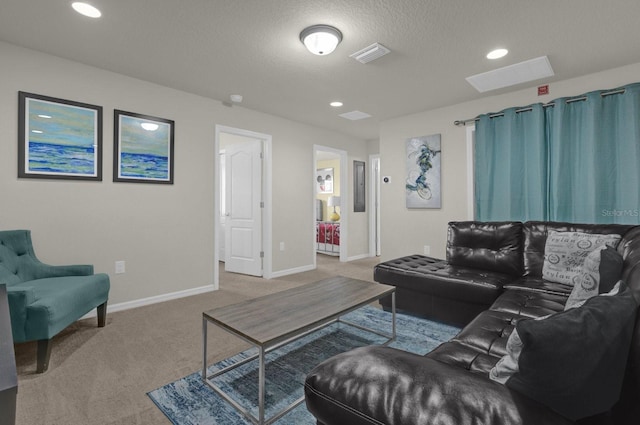 carpeted living room featuring a textured ceiling