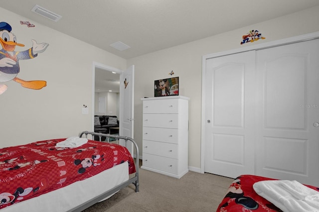 bedroom featuring a closet and light carpet