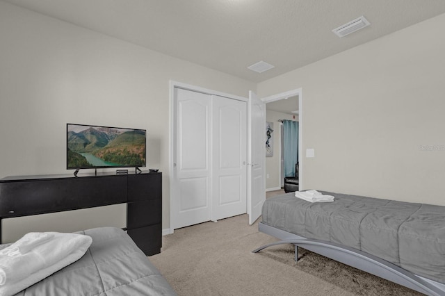 carpeted bedroom featuring a closet