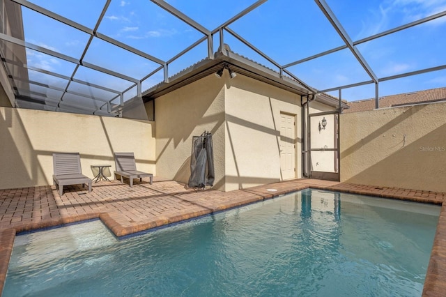 view of swimming pool with a patio and a lanai