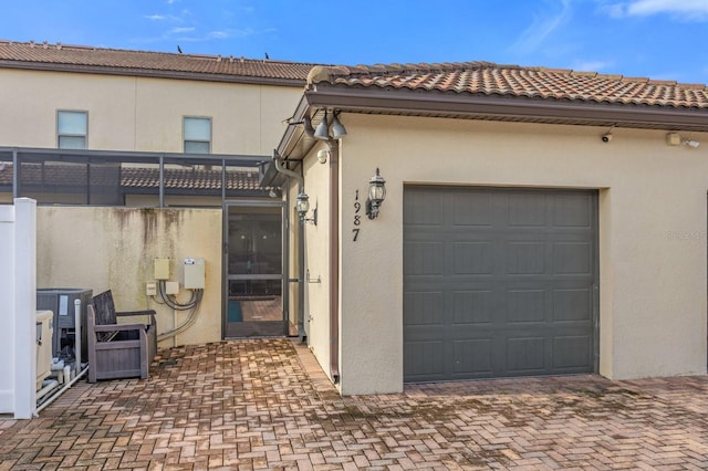 exterior space with a garage and central AC unit