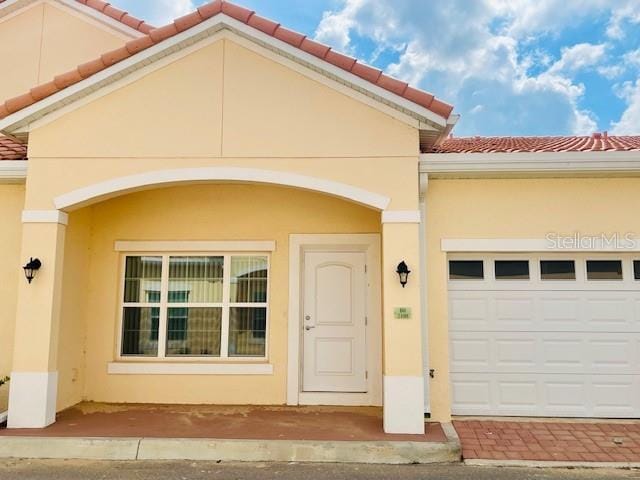 view of exterior entry featuring a garage