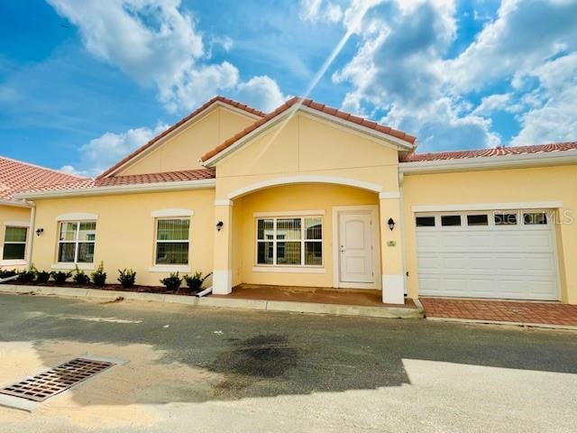 mediterranean / spanish-style home featuring a garage