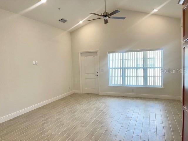 interior space with high vaulted ceiling, ceiling fan, and light hardwood / wood-style floors