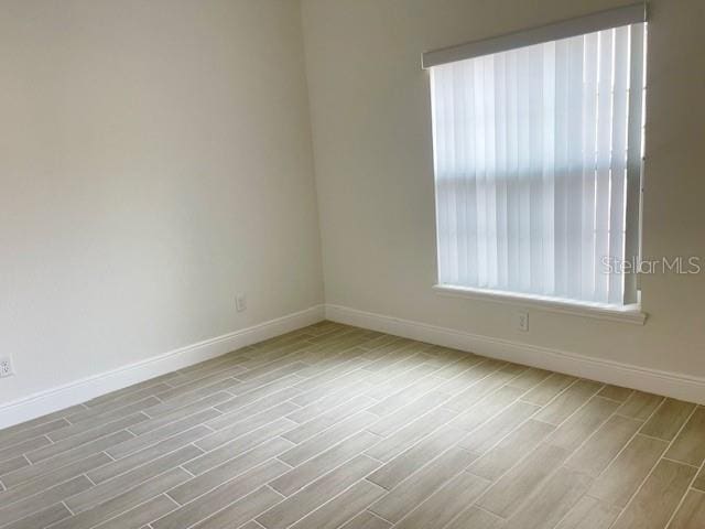 unfurnished room featuring light wood-type flooring