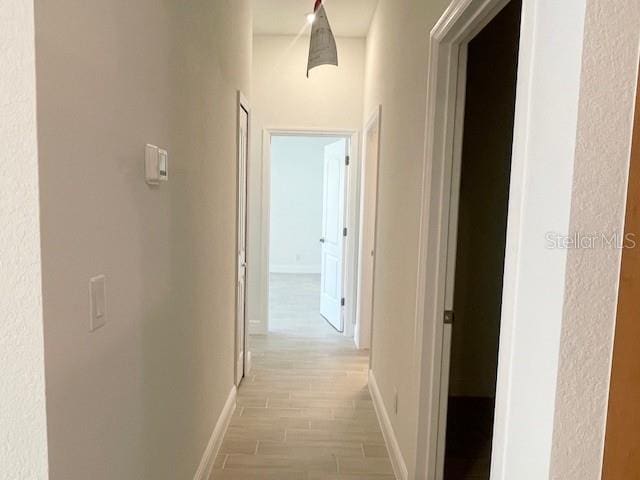 hallway with light hardwood / wood-style flooring