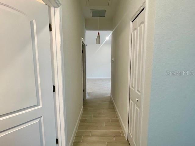 corridor with light wood-type flooring