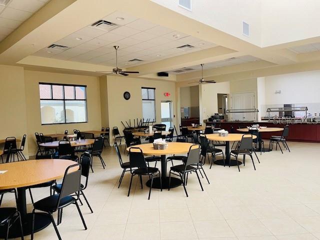 dining area featuring a high ceiling and ceiling fan