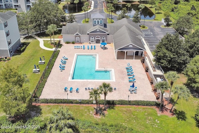 view of swimming pool featuring fence