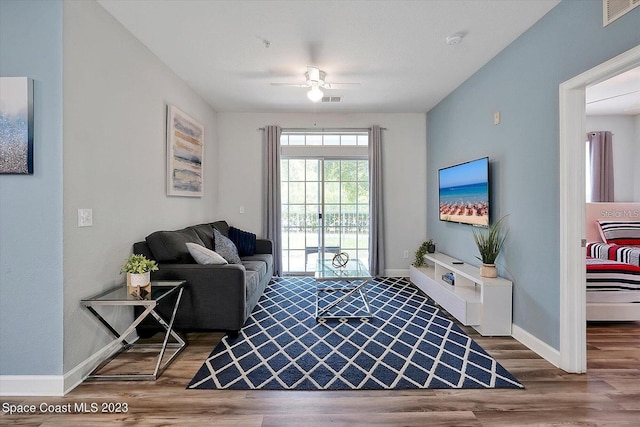 living room featuring hardwood / wood-style flooring and ceiling fan