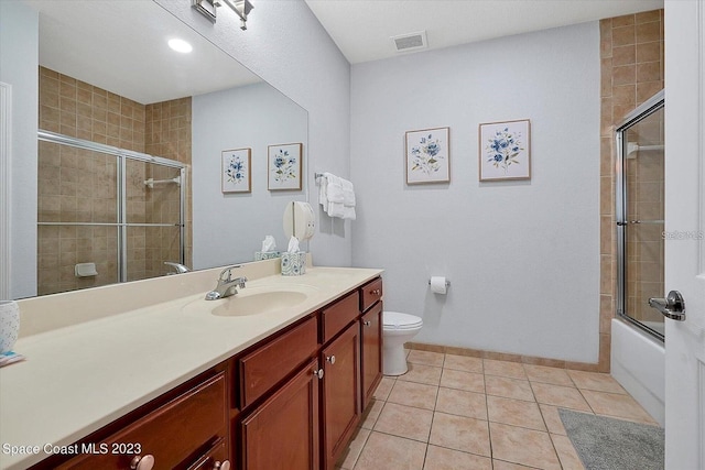 full bathroom featuring tile patterned floors, enclosed tub / shower combo, toilet, and vanity