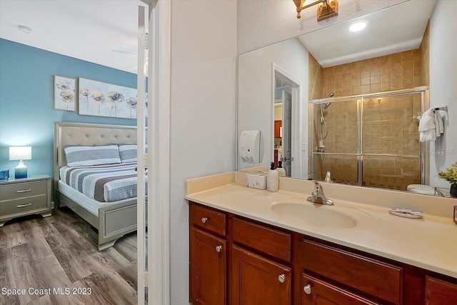 bathroom with vanity, hardwood / wood-style flooring, and walk in shower