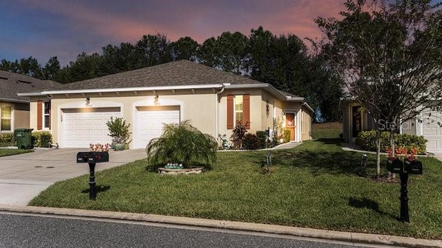 view of front facade featuring concrete driveway, a front lawn, an attached garage, and stucco siding