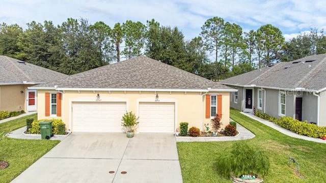 ranch-style house with stucco siding, a shingled roof, a front yard, a garage, and driveway