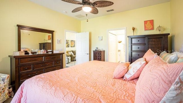 bedroom featuring ensuite bath, visible vents, and a ceiling fan