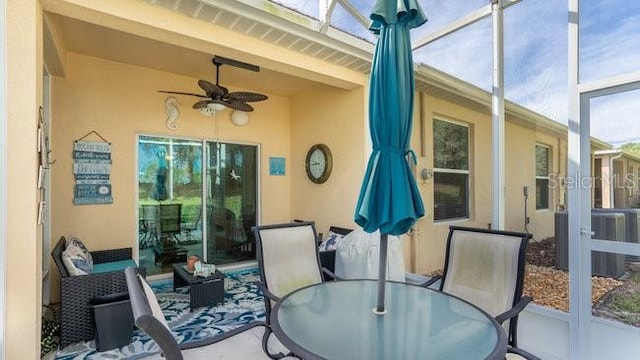 sunroom featuring ceiling fan and beamed ceiling