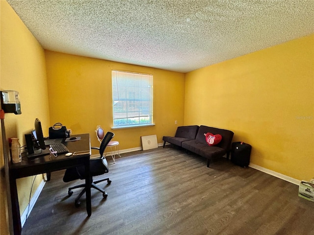 office area with dark wood-type flooring and a textured ceiling