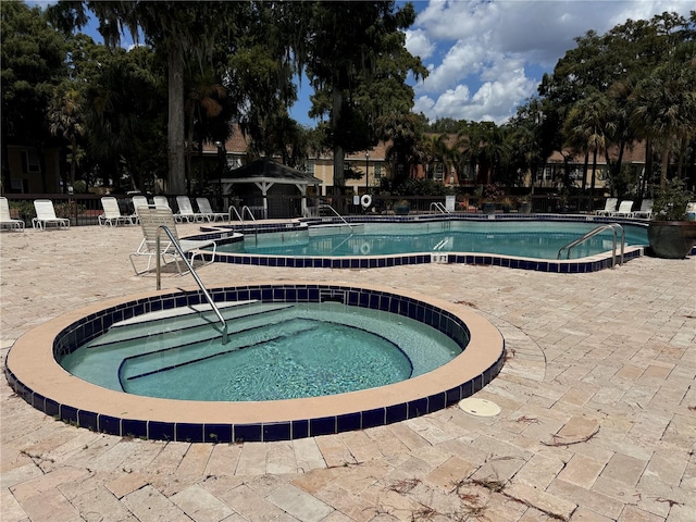 view of swimming pool with a community hot tub