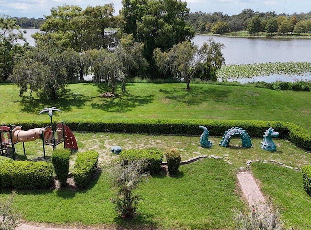 view of property's community with a yard and a water view