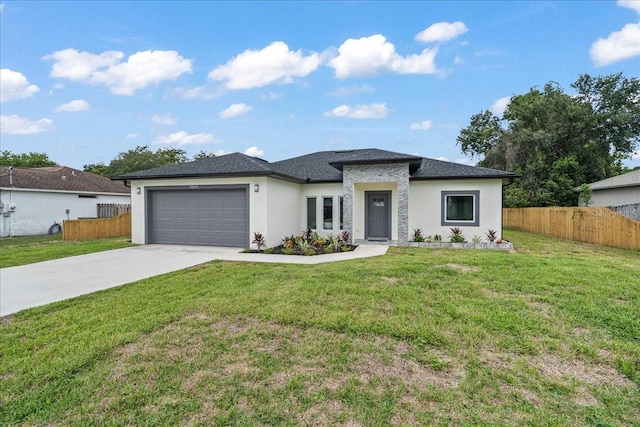 view of front facade featuring a garage and a front lawn