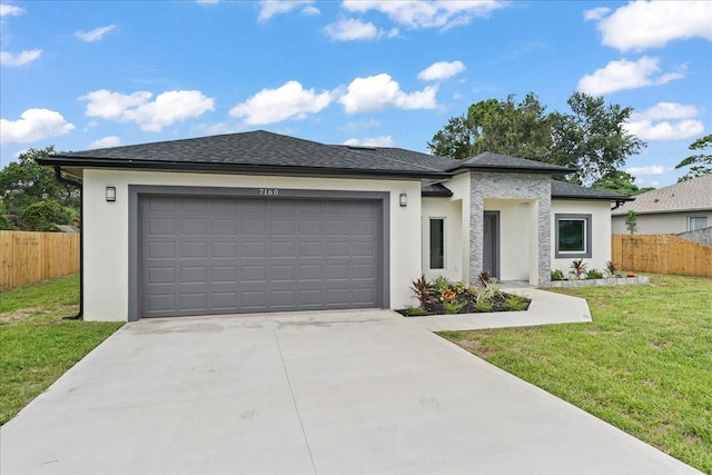 view of front of house featuring a garage and a front lawn