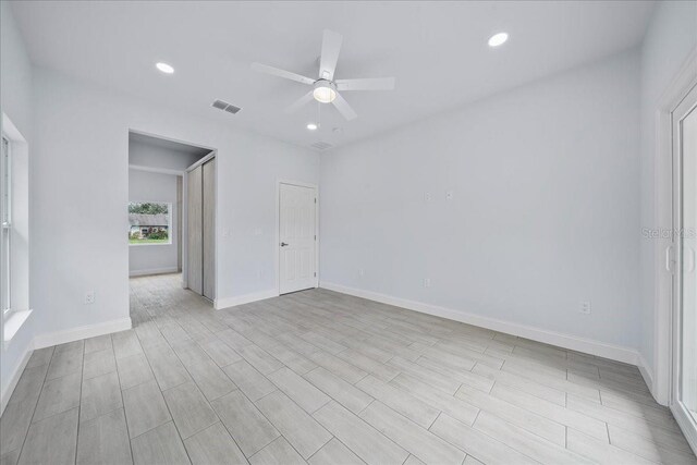 spare room featuring ceiling fan and light hardwood / wood-style flooring