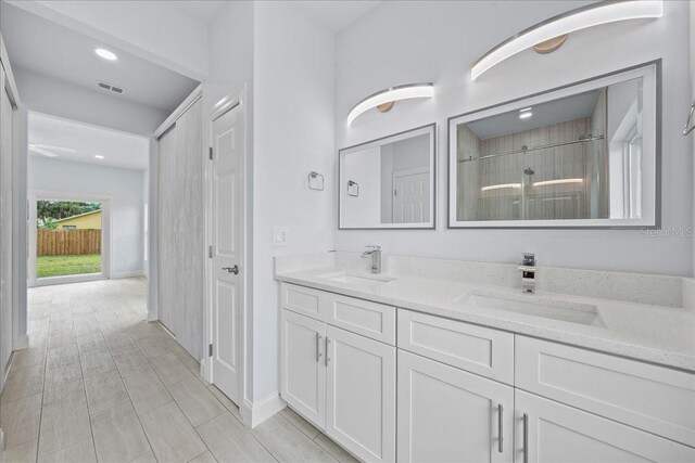 bathroom with vanity, a shower, and wood-type flooring