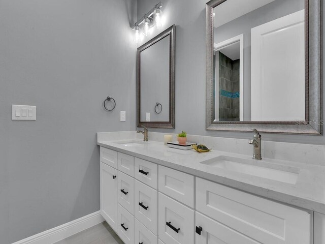 bathroom featuring tile patterned flooring and vanity