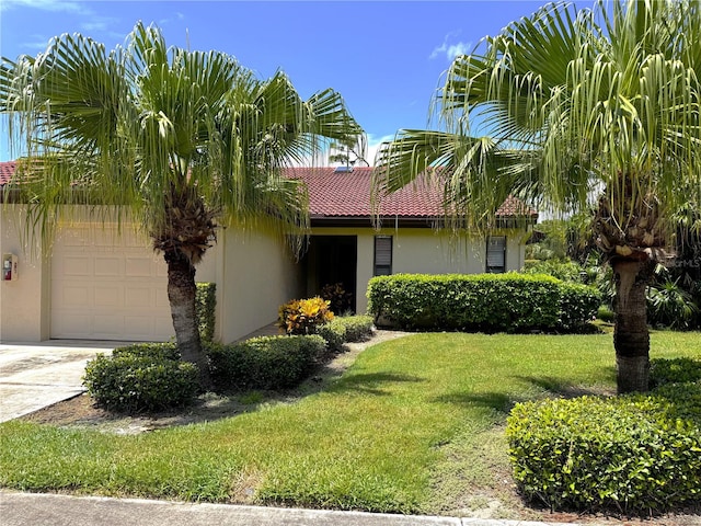 view of front facade with a garage and a front lawn