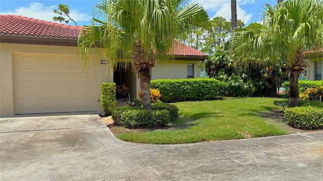 mediterranean / spanish house with a front lawn and a garage