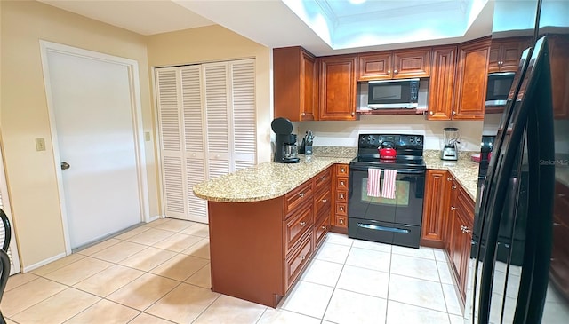 kitchen with black appliances, light stone countertops, and light tile patterned flooring