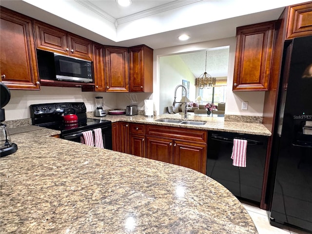 kitchen featuring an inviting chandelier, black appliances, a tray ceiling, crown molding, and sink