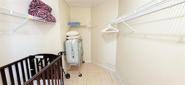 spacious closet with light tile patterned floors