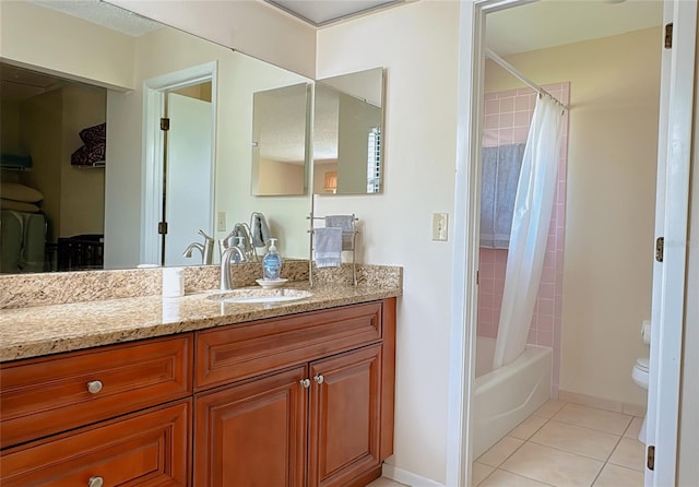 full bathroom featuring a textured ceiling, vanity, shower / tub combo with curtain, toilet, and tile patterned floors